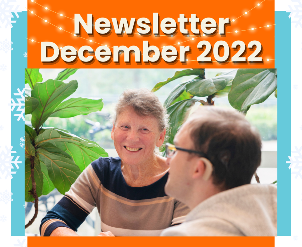 A cover page for our December 2022 newsletter. A picture of two of our consumers is in the center. Snowflakes and fairy lights line the border of the image.